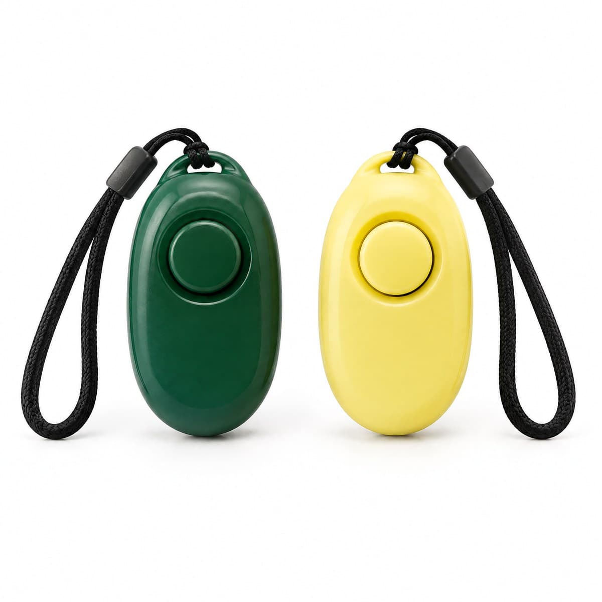Two oval training clickers side by side, one forest green and one pale yellow, each with a round button and a black cord wrist strap